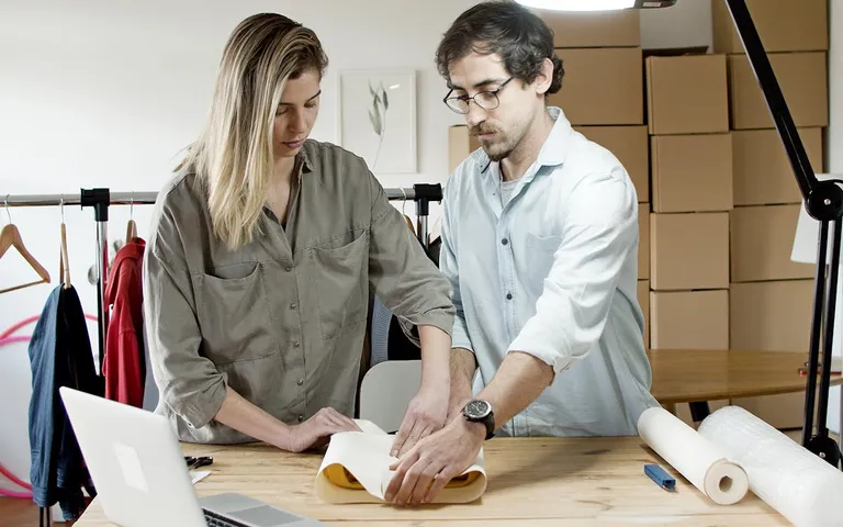 Team packing orders together in a small business workspace