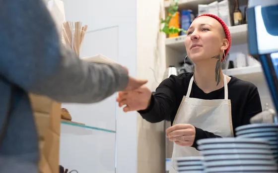 Barista serving a customer in a cozy Portugal café
