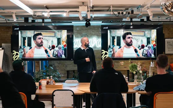Founder presenting with digital displays in a modern meeting space